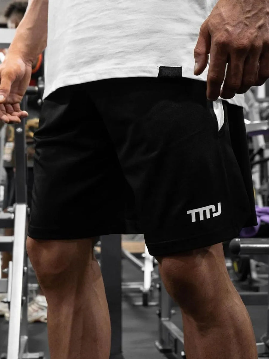 Black performance shorts with white logo detail and breathable fabric.