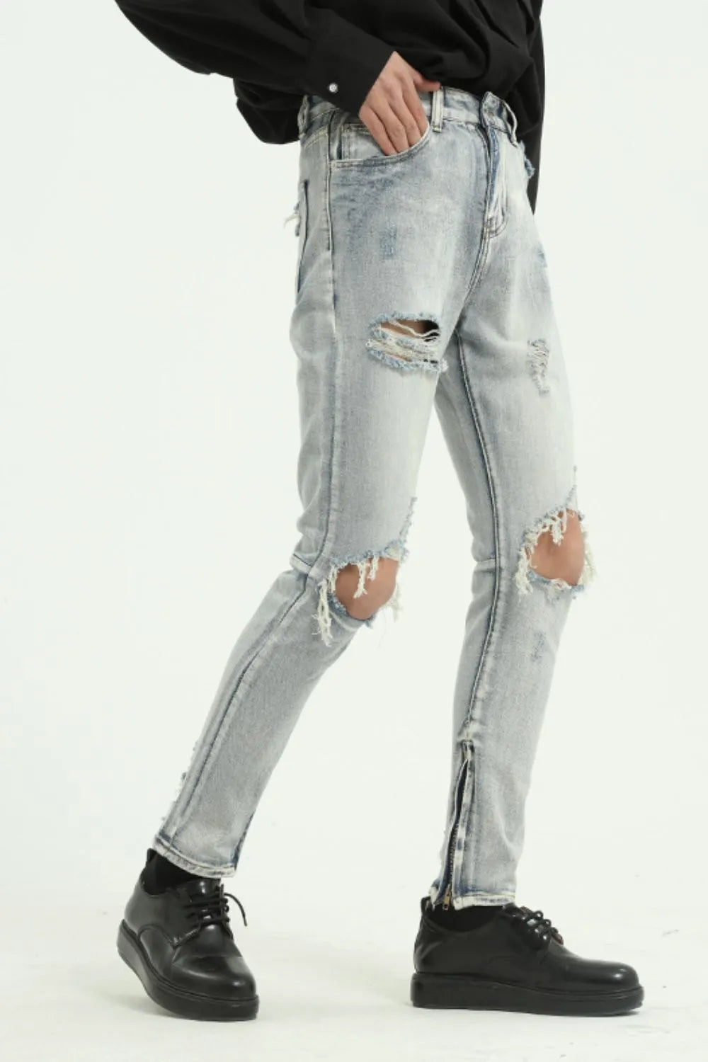 Light distressed skinny jeans with ankle zippers and ripped knees.