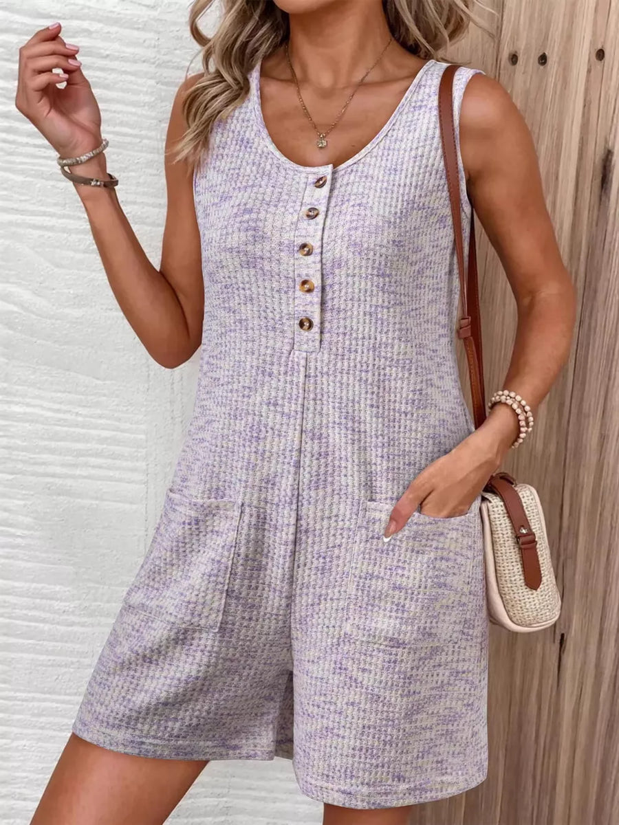 Textured button front romper in lavender with pockets and a scoop neck.