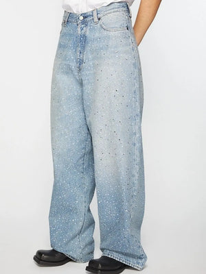 Embellished wide-leg denim trousers in medium wash with scattered rhinestones.