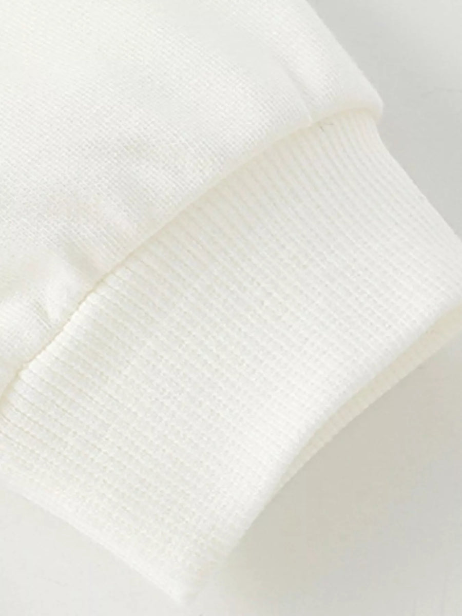 White kids' sweatshirt cuff detail with ribbed texture