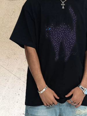 Black cotton t-shirt with cat graphic made of rhinestones and blue eyes.