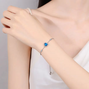 Blue heart halo moissanite adjustable bracelet with clear accent stones.