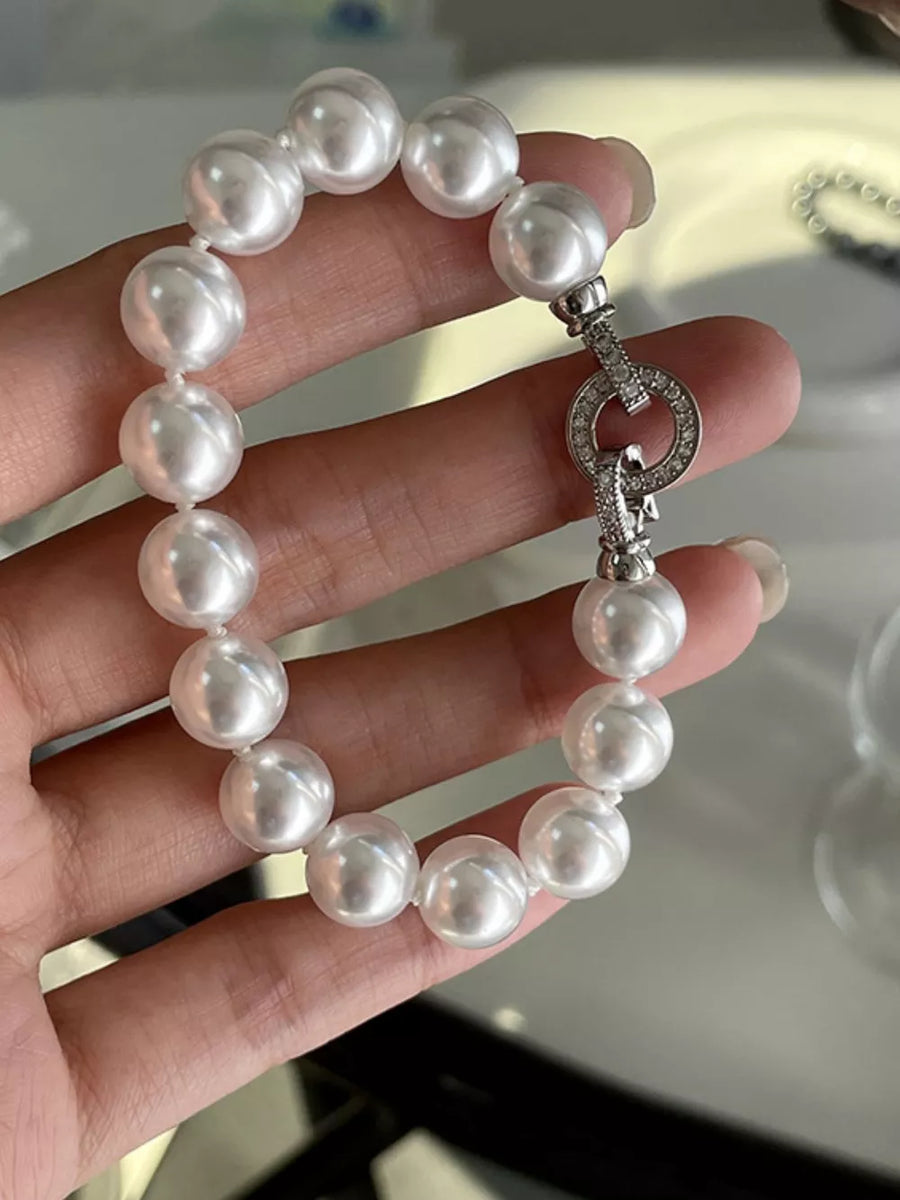 Elegant white pearl beaded bracelet with a diamond-accented clasp.