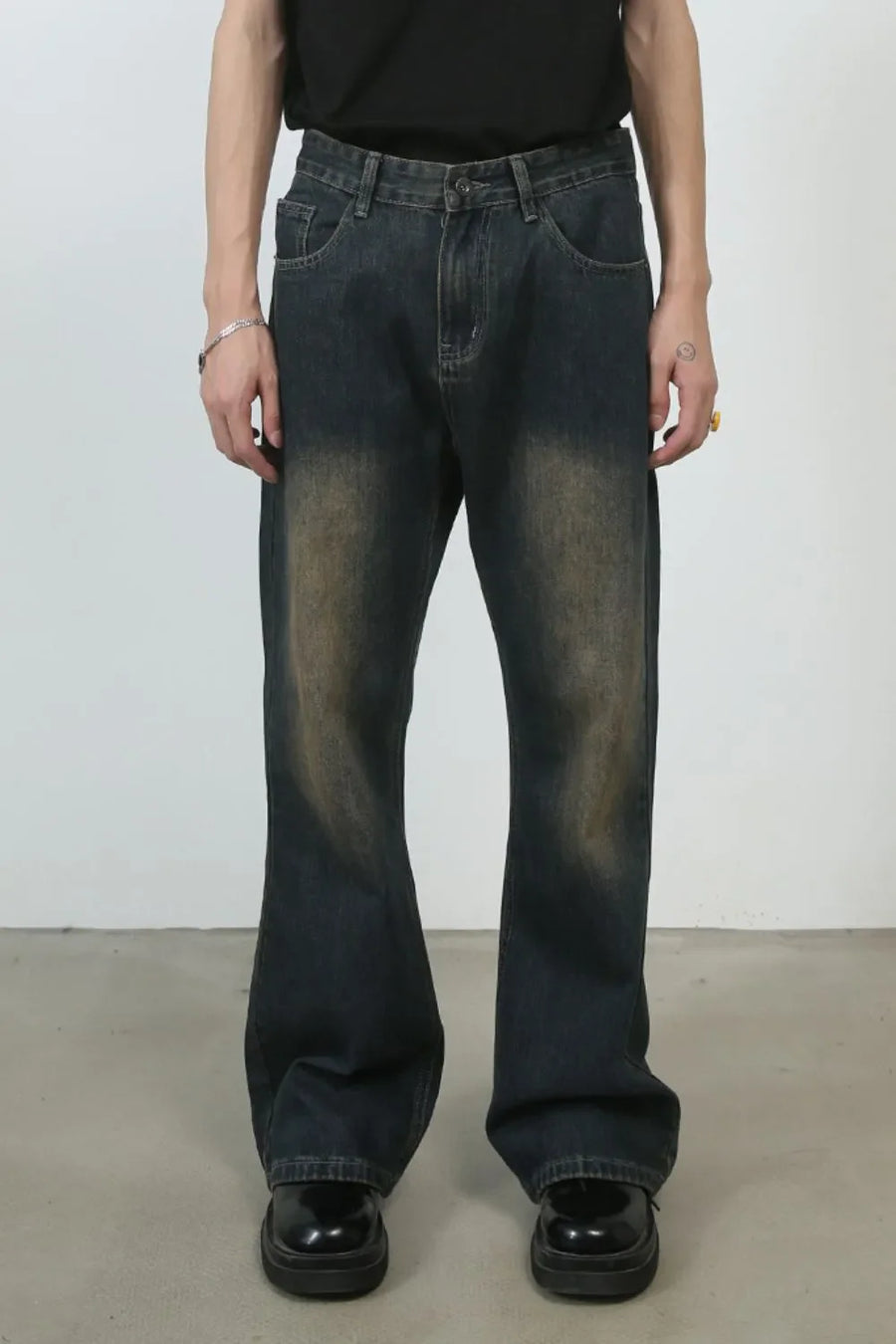 Dark wash denim flare jeans with vintage fading and baggy fit