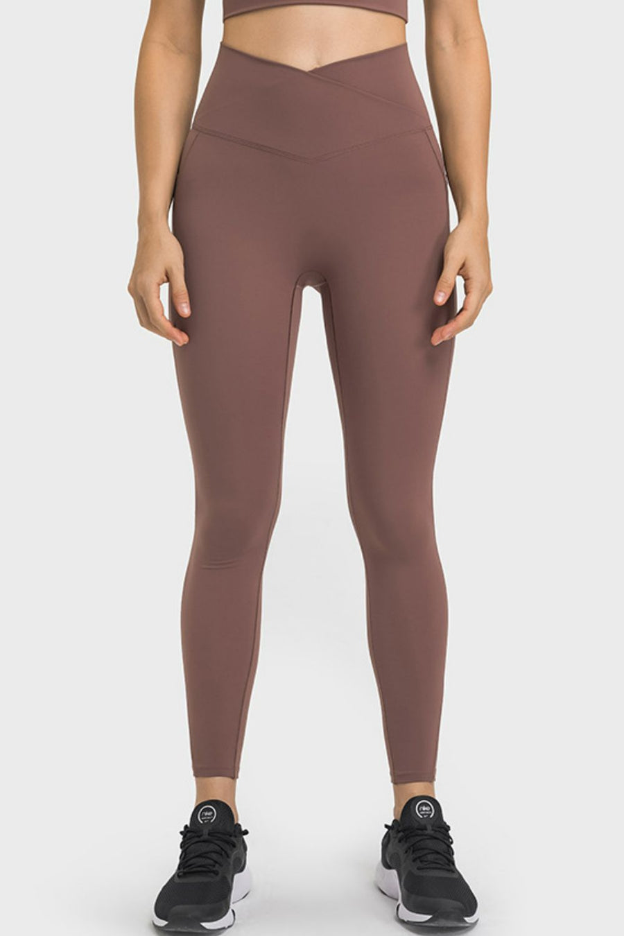 Brown performance leggings with sculpted waistband and pockets