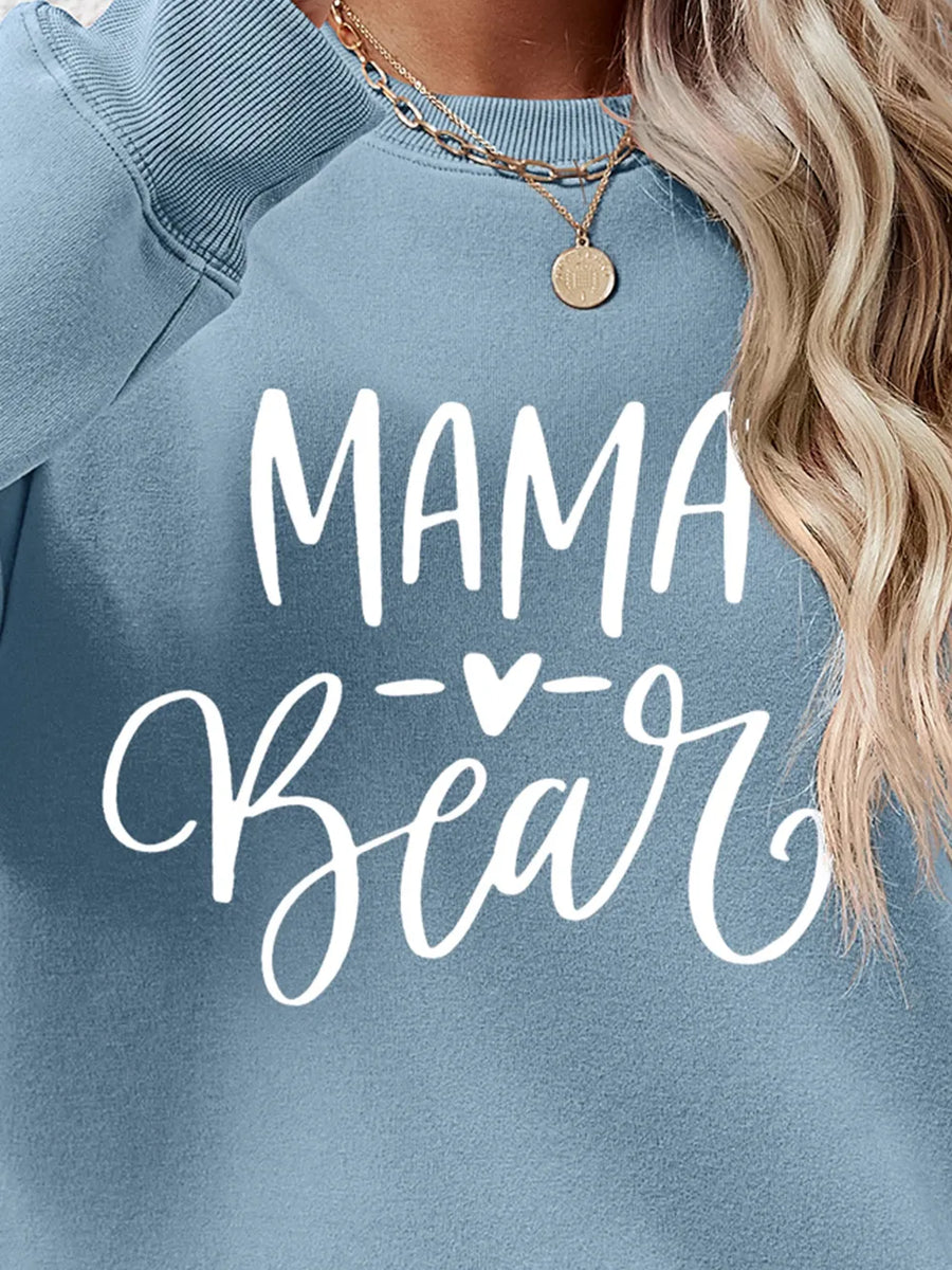 Light Blue Mama Bear graphic sweatshirt with crewneck, styled with a necklace.