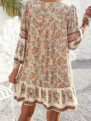 Vibrant floral print mini dress with tiered ruffle hem and bell sleeves.