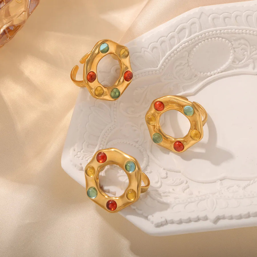 Gold statement ring with colorful gemstone halo detail, adjustable band