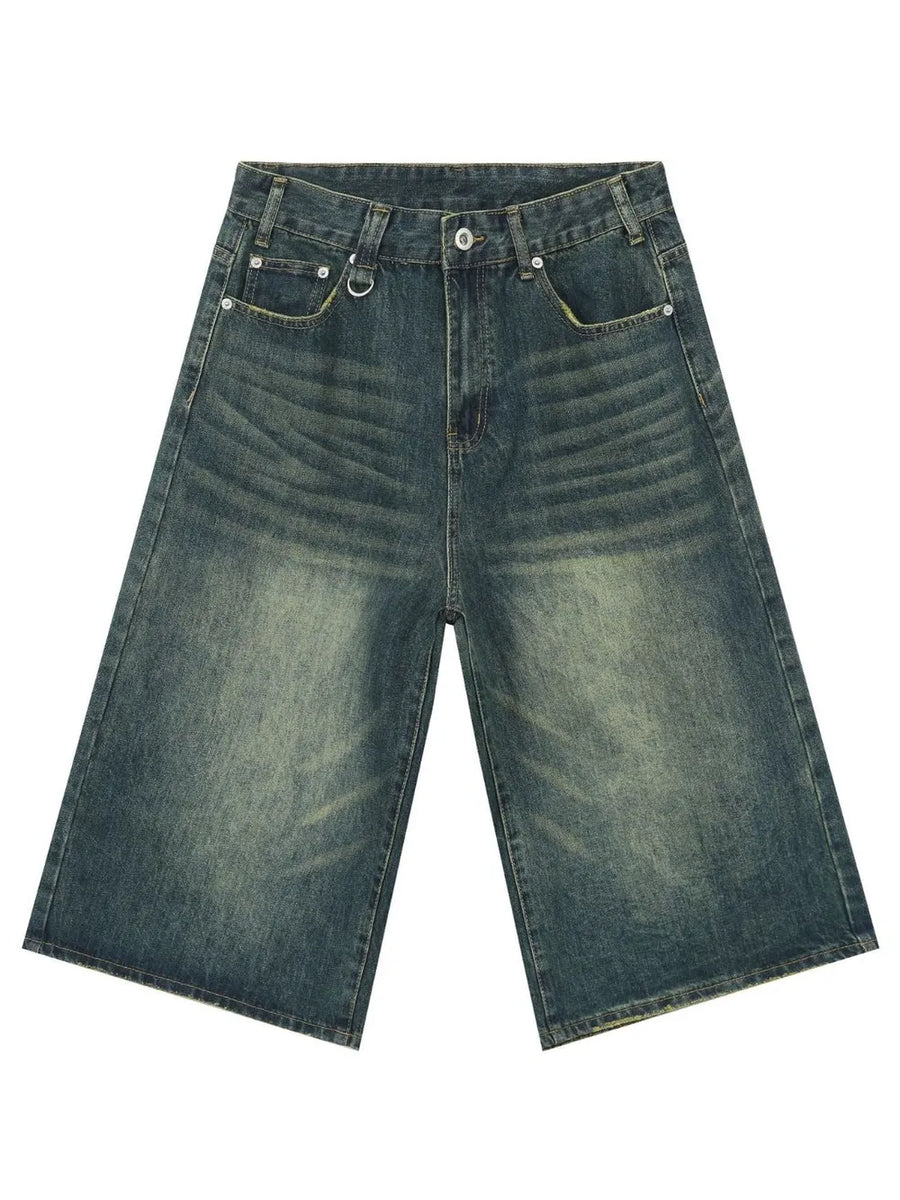 Wide-leg distressed denim culottes in a vintage blue wash with a buttoned fly and metal D-ring detail.