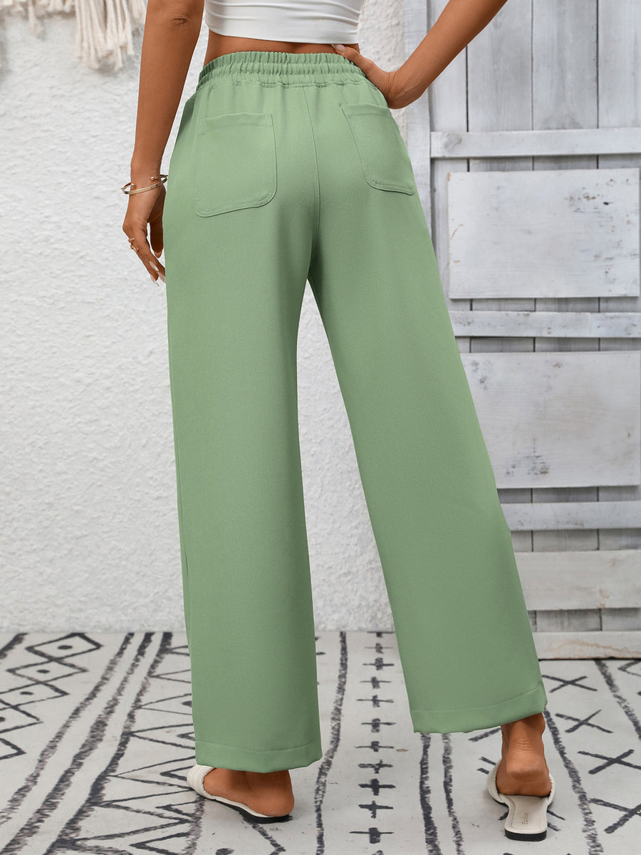 Green drawstring wide-leg pants with back pockets and elastic waistband.