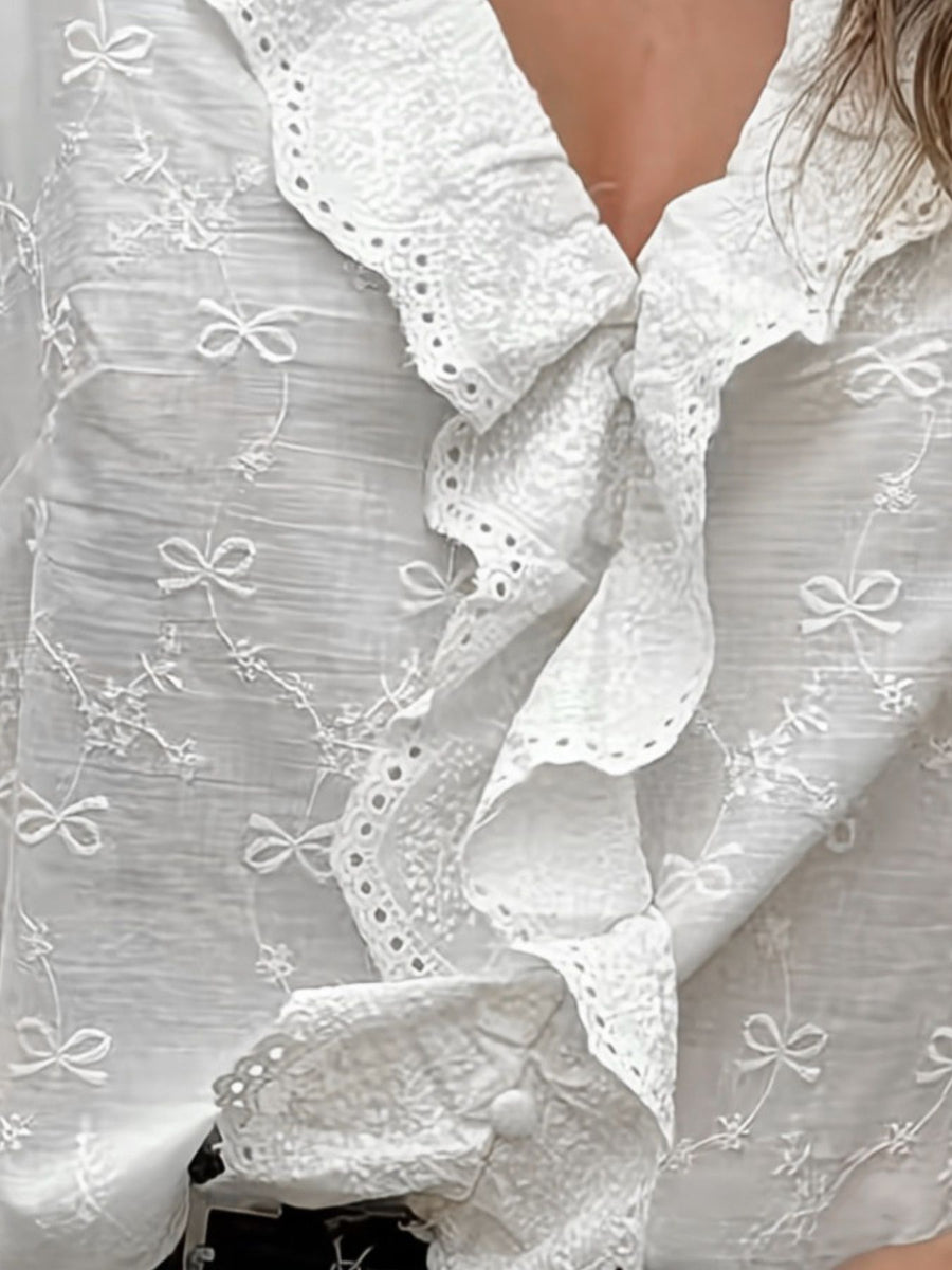 White blouse featuring ruffled and embroidered