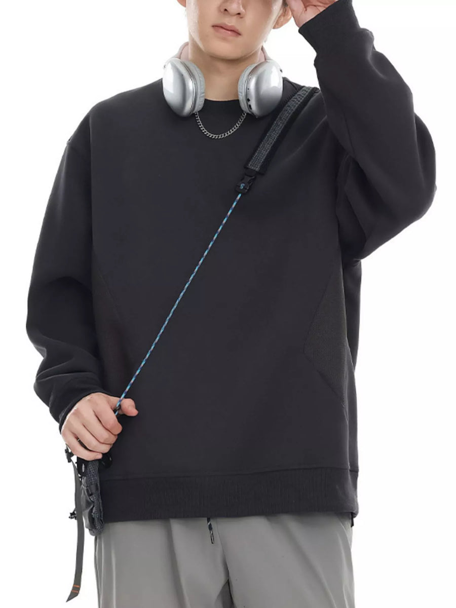 Oversized black cotton crew-neck sweatshirt with textured panel detail.