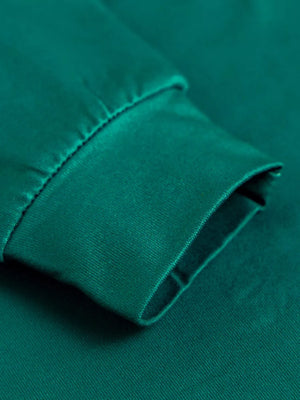 Dark green pajama sleeve cuff detail with stitching