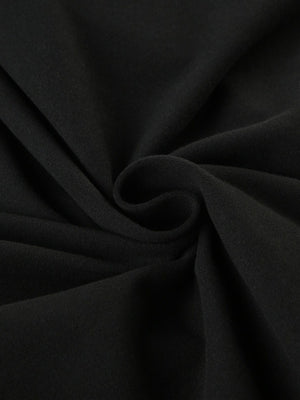 Black long-sleeve active romper with boat neck, showing fabric texture.