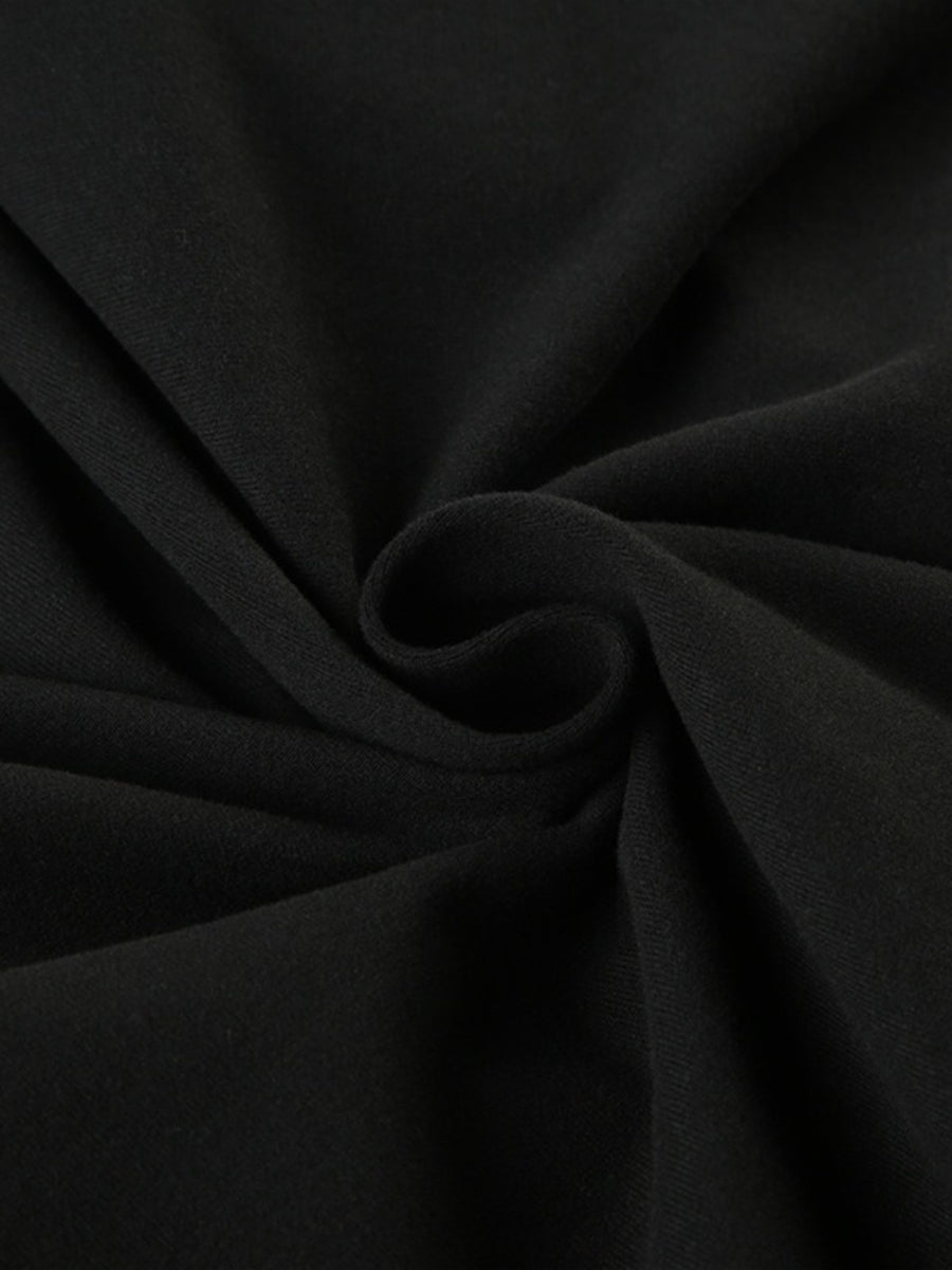 Black long-sleeve active romper with boat neck, showing fabric texture.