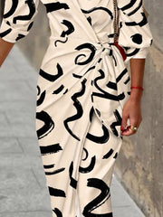 White abstract patterned shirt dress with 3/4 sleeves and a waist tie detail.