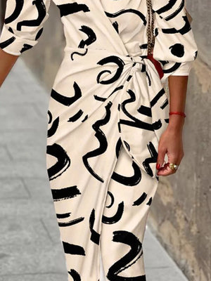 White abstract patterned shirt dress with 3/4 sleeves and a waist tie detail.