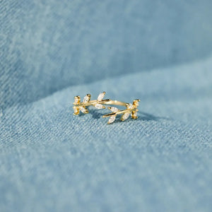 Gold open ring with branching foliage design and cubic zirconia accents
