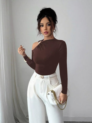 Brown cutout one-shoulder t-shirt with gold hardware detail and long sleeves.
