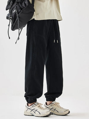 Black relaxed fit joggers with drawstring waist and elastic cuffs.
