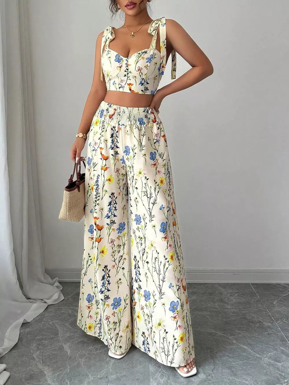 Floral print crop top and wide-leg pants set with adjustable tie straps.