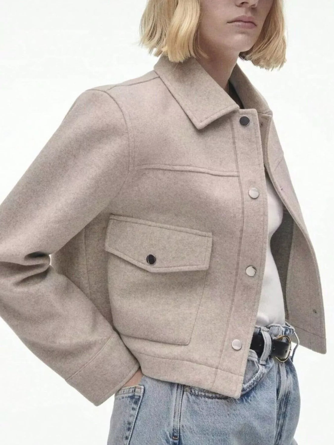 Beige trucker jacket with snap buttons, collar, and chest pockets.
