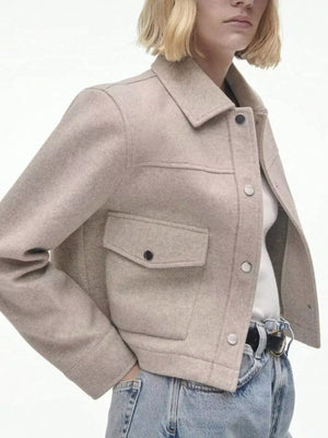 Beige trucker jacket with snap buttons, collar, and chest pockets.