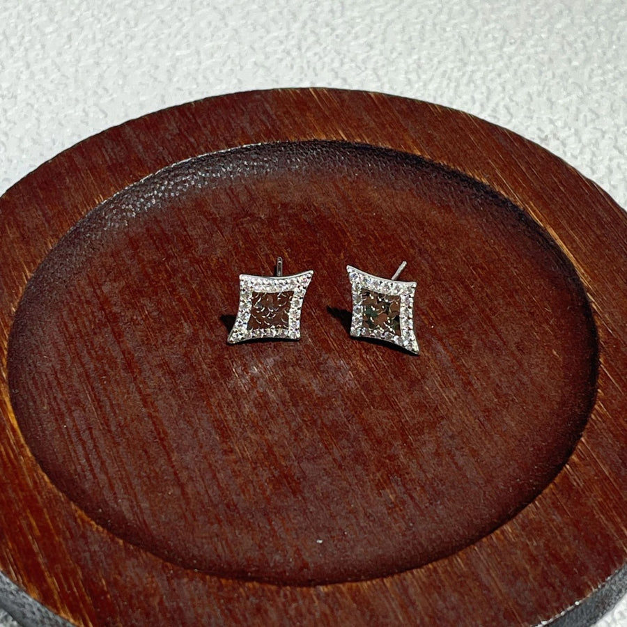 silver earrings featuring stud and geometric