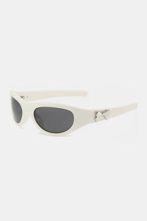 White sporty shield sunglasses with bow embellishment and dark lenses.