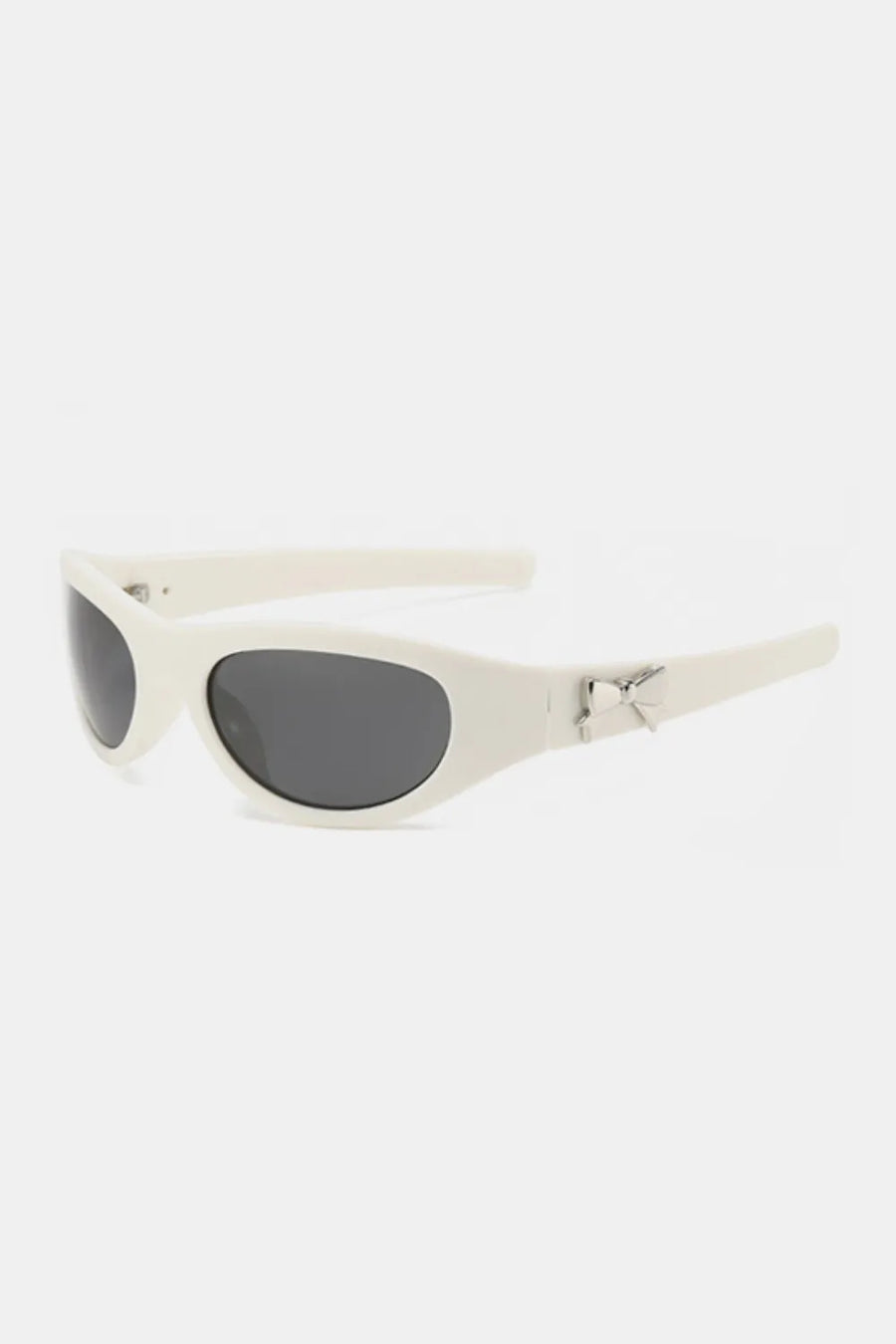 White sporty shield sunglasses with bow embellishment and dark lenses.