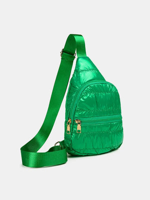 Green glossy padded sling bag with gold zippers and adjustable strap.