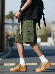 Men's green casual cargo shorts with drawstring and utility pockets.