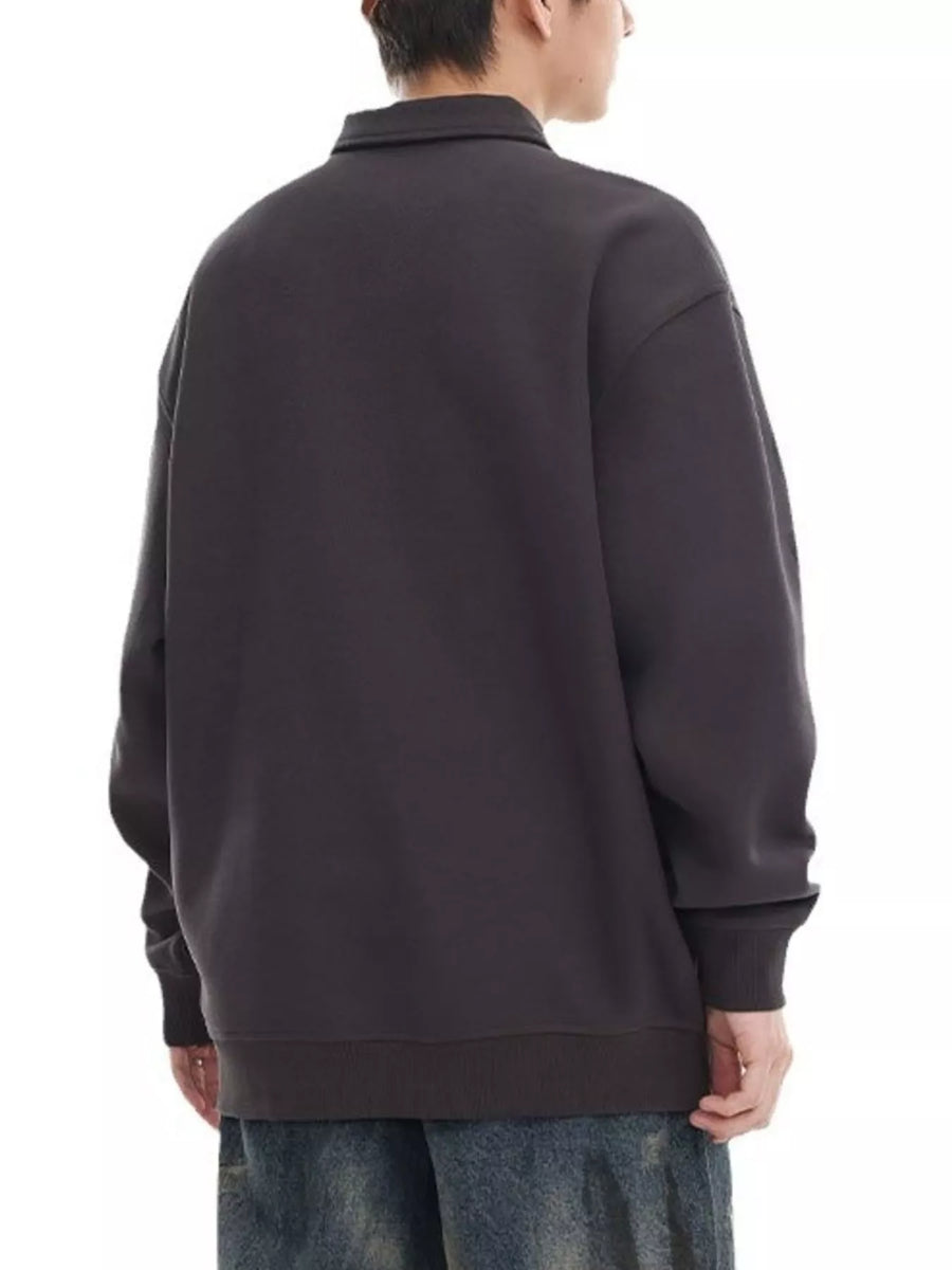 Oversized dark gray polo sweatshirt with ribbed cuffs and hem.