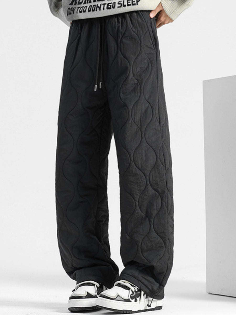 Black quilted sweatpants with relaxed fit and drawstring waist.