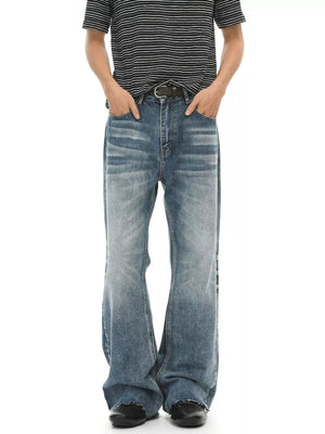 Men's blue wash cotton flare jeans with distressed detailing and frayed hem.