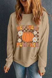 Khaki crewneck sweatshirt with retro pumpkin and daisy graphic and "Hey There Pumpkin" text.
