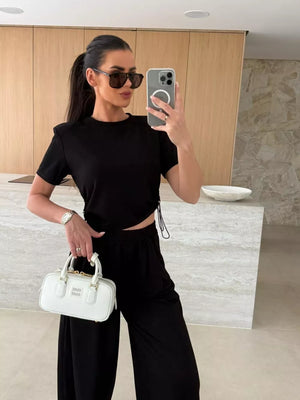 Black crop top with adjustable drawstring and wide-leg pants set.