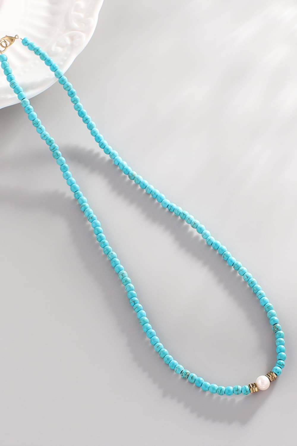 Turquoise bead necklace with pearl and gold accents