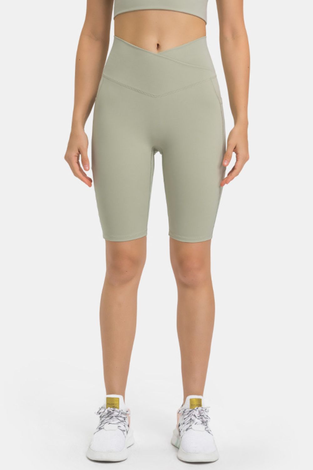 Sage V-waist pocketed performance biker shorts with a crossover waistband.