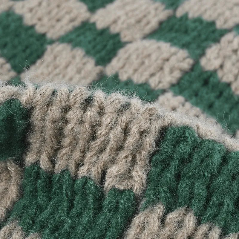 Checkerboard knit beanie in dark green and khaki with a textured weave.