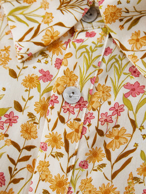 Floral print button-down shirt dress with yellow and pink flowers on a cream background.