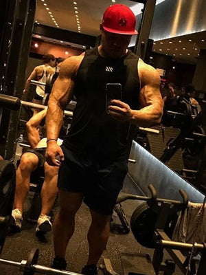 Black performance tank top with minimalist branding, crew neck, sleeveless.