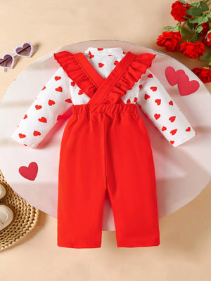 Baby girl's red suspender pants and white heart print long sleeve top set with ruffled straps.