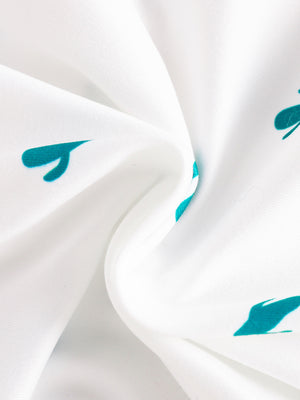 White baby bodysuit with teal cactus print