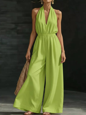 Fluorescent green wide-leg halter jumpsuit with V-neck and elastic waist.
