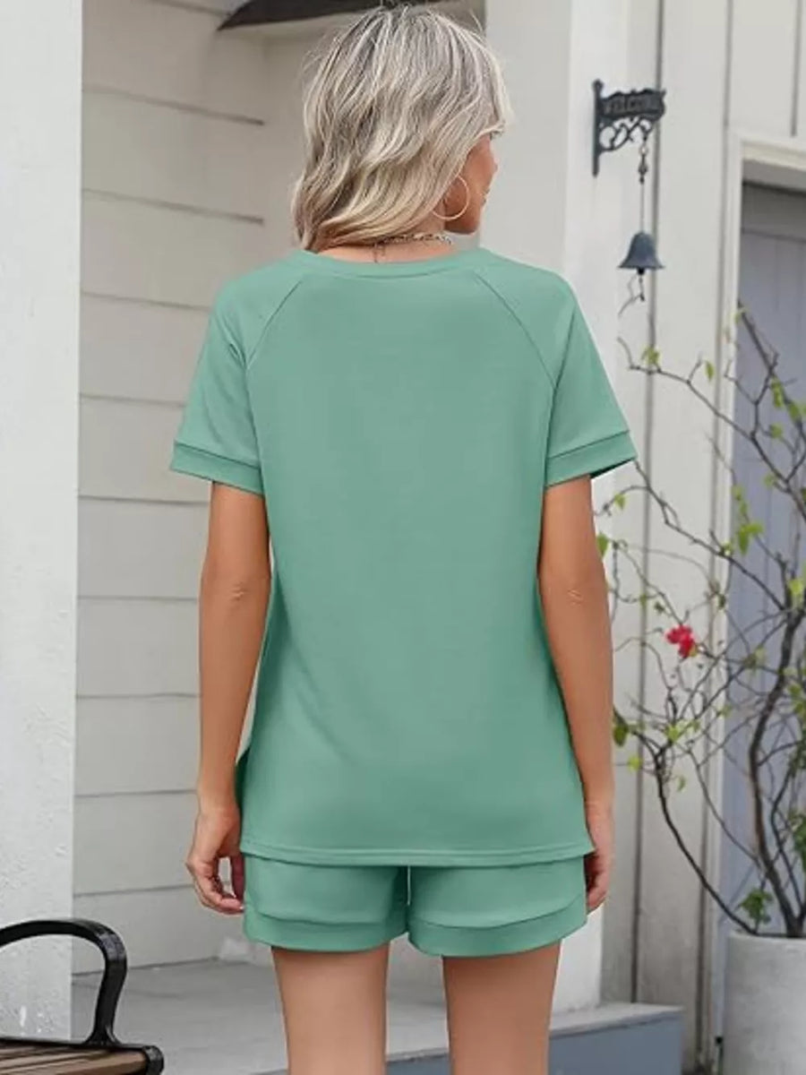 Green two-piece set with drawstring shorts and short sleeve top.