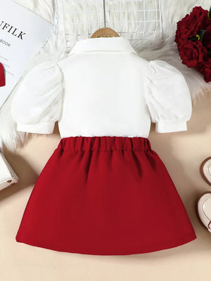 Baby girls' red skirt and white puff sleeve top ensemble with embroidered detail.