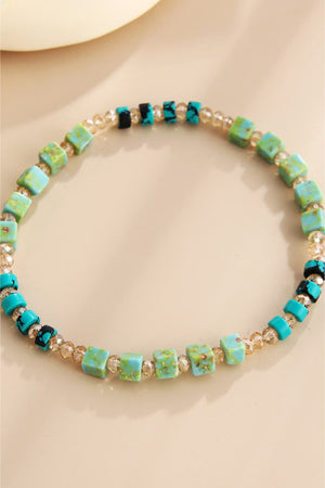 Turquoise cube and crystal beaded bracelet with teal and black accents