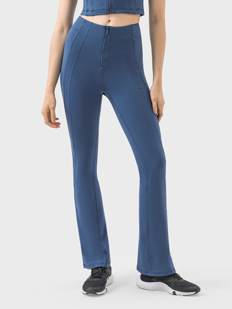 Dark blue activewear pants with a zip front and flared leg